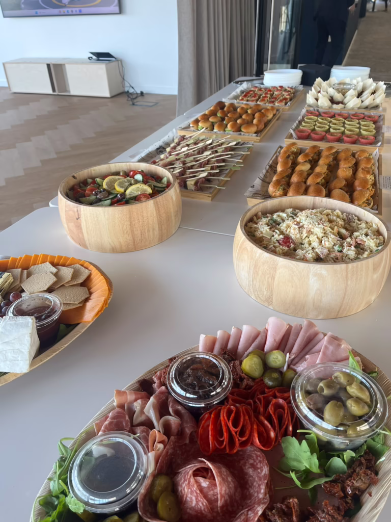 Buffet catering spread with salads, sandwiches and charcuterie
